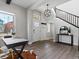 Bright entryway with hardwood floors, staircase, modern light fixture, and coat hooks at 5755 Boston St, Denver, CO 80238