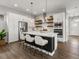 Modern kitchen featuring white cabinets, stainless steel appliances, and an island with seating at 5755 Boston St, Denver, CO 80238