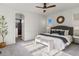 Serene bedroom featuring a tufted headboard, decorative pillows, and an ensuite bathroom at 5755 Boston St, Denver, CO 80238