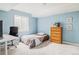 Finished basement area with neutral carpet, natural light, and a bed at 6385 S Nelson Way, Littleton, CO 80127