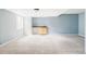 Spacious basement with neutral carpet and a built-in wet bar at 6385 S Nelson Way, Littleton, CO 80127
