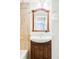 Bathroom vanity with mirror and tile wall at 6385 S Nelson Way, Littleton, CO 80127