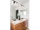 Bathroom featuring a double sink vanity with modern lighting and mirrors at 6385 S Nelson Way, Littleton, CO 80127