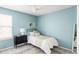 Bright bedroom with a light blue wall, ceiling fan, and bed at 6385 S Nelson Way, Littleton, CO 80127