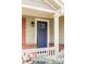 Close-up view of the elegant blue front door with brick accents and white trim, showcasing the home's inviting entrance at 6385 S Nelson Way, Littleton, CO 80127
