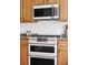 Close-up view of a modern double oven and microwave, showcasing the kitchen's high-end stainless steel appliances at 6385 S Nelson Way, Littleton, CO 80127