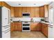Functional kitchen with wood cabinets, modern appliances, and ample counter space, perfect for cooking and entertaining at 6385 S Nelson Way, Littleton, CO 80127