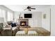 Comfortable living area with a brick fireplace, soft sofa, and neutral tones at 6385 S Nelson Way, Littleton, CO 80127
