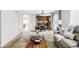 Open-concept living room leading to kitchen and dining area with a neutral color palette at 6385 S Nelson Way, Littleton, CO 80127