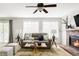 Cozy living room featuring a brick fireplace, plush seating, and stylish decor at 6385 S Nelson Way, Littleton, CO 80127