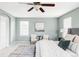 Bright main bedroom with a ceiling fan, sitting area and stylish decor at 6385 S Nelson Way, Littleton, CO 80127