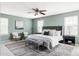 Spacious main bedroom with a ceiling fan, accent chairs and plush furnishings at 6385 S Nelson Way, Littleton, CO 80127