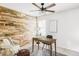 Office area with ceiling fan, desk, and decorative wood wall at 6385 S Nelson Way, Littleton, CO 80127