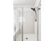 Bathroom featuring a tile shower with glass doors and modern fixtures at 6385 S Nelson Way, Littleton, CO 80127
