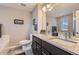 Bathroom featuring a double vanity with granite countertop, large mirror, and modern fixtures at 3795 Depew St # D, Wheat Ridge, CO 80212