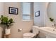 A clean half bath features neutral walls, a modern vessel sink, and decorative wall art at 3795 Depew St # D, Wheat Ridge, CO 80212