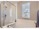 Bright bathroom featuring a shower, soaking tub, and a large window at 3795 Depew St # D, Wheat Ridge, CO 80212
