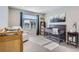 Bright Bedroom featuring a cozy chair, artwork, modern crib, and natural light creates a calming atmosphere at 3795 Depew St # D, Wheat Ridge, CO 80212