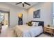 Calming bedroom features a walk-in closet, ceiling fan, neutral colors, and contemporary furnishings at 3795 Depew St # D, Wheat Ridge, CO 80212