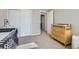 Comfortable carpeted bedroom with large closet, changing table, and ample sunlight creates an inviting Bedroom at 3795 Depew St # D, Wheat Ridge, CO 80212