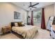 Comfortable bedroom features a ceiling fan, large window, neutral tones, and stylish decor at 3795 Depew St # D, Wheat Ridge, CO 80212