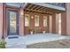 Inviting front porch with a bench, planters, and a covered area with exposed beam rafters at 3795 Depew St # D, Wheat Ridge, CO 80212