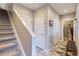 Hallway with gray walls, white trim, and a staircase leading to the upper level with a tiled floor at 3795 Depew St # D, Wheat Ridge, CO 80212