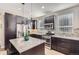 Modern kitchen with a central island and stainless steel appliances and pendant lighting at 3795 Depew St # D, Wheat Ridge, CO 80212