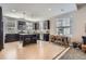 Modern kitchen with an island, stainless appliances, and hardwood floors leading to the dining area at 3795 Depew St # D, Wheat Ridge, CO 80212
