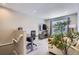 Upstairs living room featuring a work area, comfortable sofa, and large windows with natural light at 3795 Depew St # D, Wheat Ridge, CO 80212