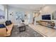 Cozy living room with a tan sofa, a patterned rug, and natural light streaming through the window at 3795 Depew St # D, Wheat Ridge, CO 80212
