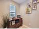 This office features a sleek wooden cabinet with a printer, decor, and a sunlit window with blinds at 3795 Depew St # D, Wheat Ridge, CO 80212