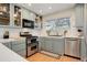 Updated kitchen with light blue cabinets, stainless steel appliances and hardwood floors at 10395 Red Mountain E, Littleton, CO 80127