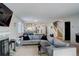 Open concept living room with fireplace and view of kitchen at 10395 Red Mountain E, Littleton, CO 80127