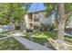 Charming two-story condo with lush landscaping, trees, and easy access to parking and outdoor spaces at 4068 S Atchison Way # 101, Aurora, CO 80014