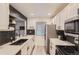 Bright kitchen with stainless steel appliances, herringbone backsplash, and stainless steel sink at 4068 S Atchison Way # 101, Aurora, CO 80014