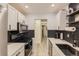 Galley kitchen featuring white cabinets, stainless steel appliances, and herringbone backsplash at 4068 S Atchison Way # 101, Aurora, CO 80014