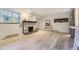 Spacious living room with hardwood flooring, stone fireplace, natural light, and contemporary design at 4068 S Atchison Way # 101, Aurora, CO 80014