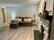 Cozy living room with modern sectional sofa and stone fireplace providing a relaxing atmosphere at 4068 S Atchison Way # 101, Aurora, CO 80014