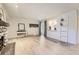 Bright living room with light wood floors, stone fireplace, and sliding glass door leading to outdoor space at 4068 S Atchison Way # 101, Aurora, CO 80014