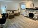 Living room featuring hardwood flooring, stone fireplace, natural light, and modern furnishings at 4068 S Atchison Way # 101, Aurora, CO 80014