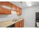 Functional kitchen with wood cabinets, light countertop, and essential appliances at 9220 E Girard Ave # 2, Denver, CO 80231