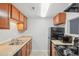 Functional kitchen featuring appliances, light countertops, and wood cabinets at 9220 E Girard Ave # 2, Denver, CO 80231