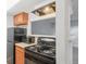 Modern kitchen features black appliances and wood cabinets at 9220 E Girard Ave # 2, Denver, CO 80231