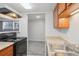 Updated kitchen featuring wood cabinets and a double sink at 9220 E Girard Ave # 2, Denver, CO 80231