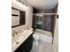 Bathroom featuring a shower with decorative tile, frameless glass, and a modern sink at 14396 E Temple Pl # A, Aurora, CO 80015