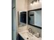 Bathroom with a white vanity, granite countertops, double mirrors, and a modern faucet at 14396 E Temple Pl # A, Aurora, CO 80015