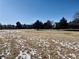 A field of grass and snow with neighborhood in the background at 14396 E Temple Pl # A, Aurora, CO 80015