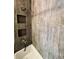 Shower with dark decorative tiling and integrated shelving niche at 14396 E Temple Pl # A, Aurora, CO 80015