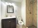 Well-lit bathroom featuring a stylish vanity and a tiled shower with a modern shower head at 2325 S Linden Ct # 211, Denver, CO 80222